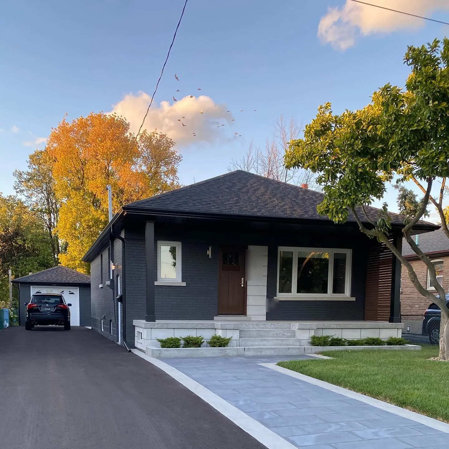 Project Valermo after — Roof extension with black soffit and eavestrough on a bungalow